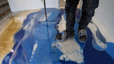 Person using Metallic Colored Epoxies 18 Inch Epoxy Trowel Spreader Tool for Epoxy Resin Floors And Walls, smoothing liquid on floor