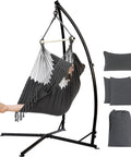 Hammock Chair With Stand For Indoor And Outdoor Use, Chill Egg Swing Chair With Patented Adjustable Pillow, Two Cushions, Side Pocket, Bag Included, 350 Lb Capacity, Dark Gray with a person relaxing in it.