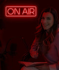 Woman with On Air Neon Sign LED Light For Streamers And Gamers Red Lit On Air Sign For Twitch YouTube TikTok Streaming