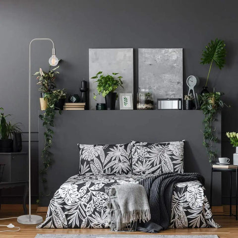 Bedroom with Holden 70 Inch Floor Lamp in Brushed Steel with Inline On Off Foot Switch next to a bed against a dark wall