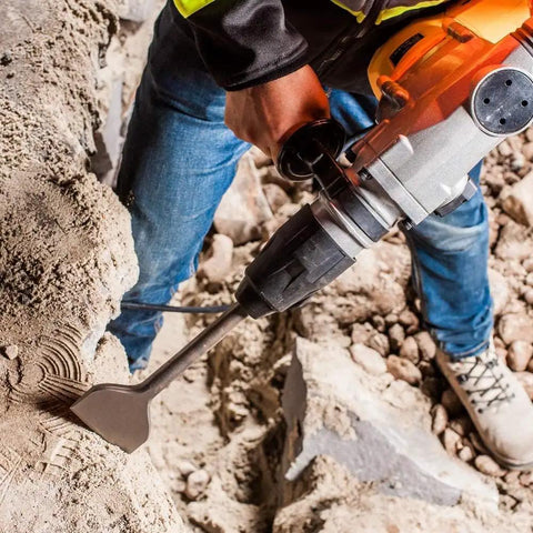 Worker using 12 Inch SDS Max Drill Bit Set For Rotary Hammer Chisels Point Flat Scaling 3 Pieces With 18mm Shank for concrete demolition
