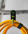 180 Degree Rotating Cordless Drill Holster Hook With Foldaway Design mounted on a ladder, holding yellow cord
