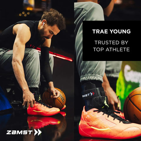 Athlete wearing ZAMST ankle brace, tying bright orange sports shoe during basketball game preparation.