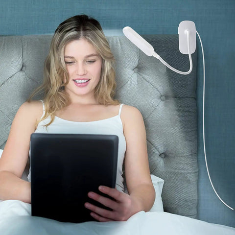 Clip On Desk Lamp With Flexible Gooseneck 7W 2600mAh Battery Operated Rechargeable Reading Light next to woman on bed