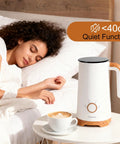 Powerful 4 In 1 Electric Milk Frother And Warmer With Dual Whisks beside a sleeping woman, showcasing quiet operation