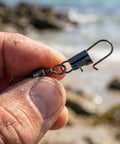 Close-up of a 200 Piece Barrel Snap Swivel Fishing Accessories Set With Ball Bearing Swivels And Snap Connectors by the sea.