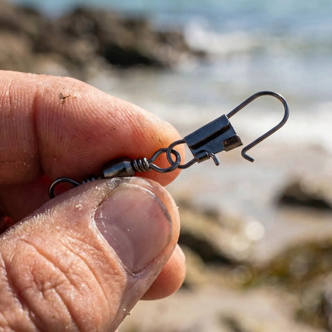 Close-up of a 200 Piece Barrel Snap Swivel Fishing Accessories Set With Ball Bearing Swivels And Snap Connectors by the sea.
