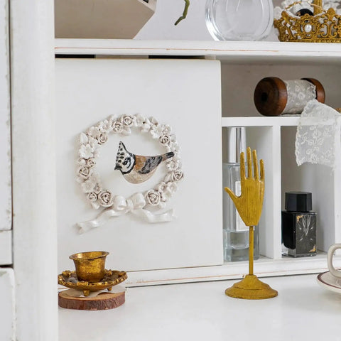 Set Of Four Metal Bird Cabinet Knobs With Colorful 3D Design Decorative Pull Handles For Doors Cabinets And Drawers Vintage Pewter Finish Delicate Yet Bold Home Decor set against a vintage-style cabinet with decorative items.