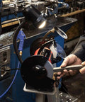 Powerful Eight Inch Bench Grinder Boots Kickin Three Quarter Horsepower Motor used for cutting metal with sparks and on-board work lamp.