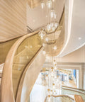 Elegant spiral staircase with hanging lights in modern interior space