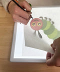 Portable LED Light Pad For Crafting And Quilting 10 By 13 Inch, showing tracing of cartoon caterpillar, bright illumination for crafts.