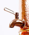 Close-up of tap on Hammered Copper Water Dispenser Pot 10 Liter With Brass Stand Tap And Knob Includes 4 Copper Tumblers
