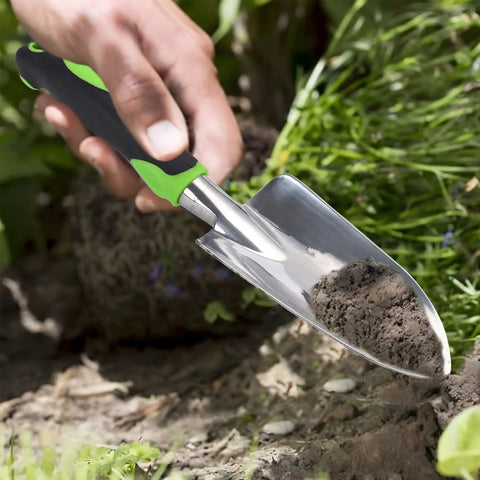 Person using Heavy Duty Cast Aluminum Garden Hand Shovel And Trowel For Planting Transplanting Weeding And Digging Soil With Soft Rubberized Non Slip Grip Handle 11.8 Inch Green Workhorse Tool for gardening