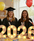 Graduates with diplomas and lit 2026 Graduation Decorations LED Marquee Numbers Light Up 2026 for Class of 2026 Party Vibe