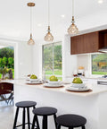 Brass Showstopper Pendant Light Fixture for Kitchen Island and Living Room Modern Ceiling Lighting with Unique Design visible over island.