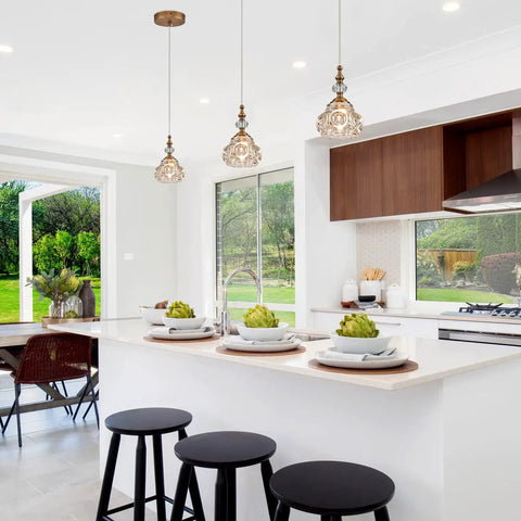 Brass Showstopper Pendant Light Fixture for Kitchen Island and Living Room Modern Ceiling Lighting with Unique Design visible over island.