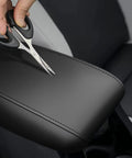 Center Console Cover for Subaru Forester 2019 2025 Armrest Protector with Black Stitching being tested for durability with scissors.