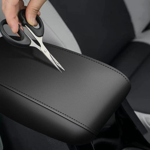 Center Console Cover for Subaru Forester 2019 2025 Armrest Protector with Black Stitching being tested for durability with scissors.