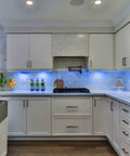 Modern kitchen with RGB Under Cabinet Lights 8 Pack App Controlled Dope Music Sync Puck Lights illuminating white cabinets