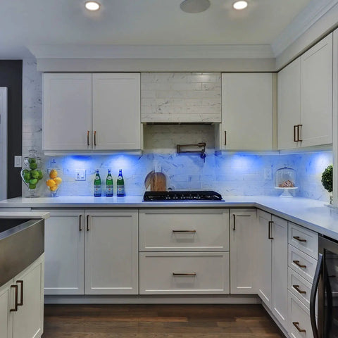 Modern kitchen with RGB Under Cabinet Lights 8 Pack App Controlled Dope Music Sync Puck Lights illuminating white cabinets