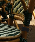 Rattan chair with black clip securing sections, showcasing 4 Pack Sectional Sofa Clips And Patio Furniture Fasteners Lightweight Wicker Rattan Couch Clamps Easy Connectors For Outdoor Sofa Sections Secure Durable Clamp Set For Tight No Fuss Bonding.