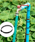 Black worm gear clamp on blue pipe, shown with four piece two point five inch hose clamp set with adjustable range 40 to 64 mm stainless steel duct and fuel line clamps black worm gear clamps for auto pipes and tubes DIY friendly.
