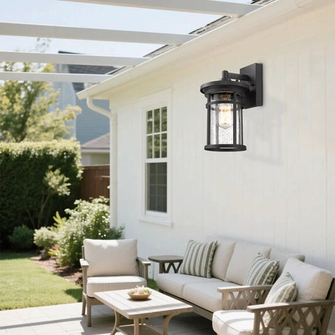 Black Outdoor Wall Light Fixture Seeded Glass Modern Farmhouse Exterior Lantern with E26 Base on a patio wall