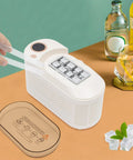 Quick Chill Portable Ice Cube Maker For Home Or Car, white compact design with ice cubes and serving tools on a table.