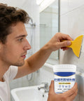 Man using All In One Wall Repair Kit With Easy To Use Putty 500G Quick Drying Filler for Cracks in bathroom wall