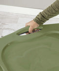 Hand gripping the full grip handle of a Roomy 17.5 Gallon Plastic Storage Bin With Secure Stackable Lid And Opaque Base.