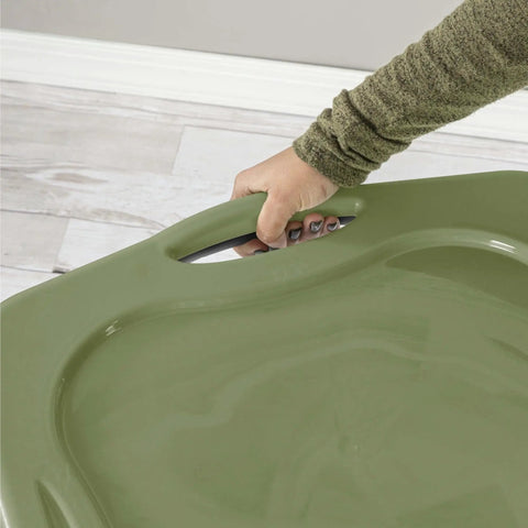 Hand gripping the full grip handle of a Roomy 17.5 Gallon Plastic Storage Bin With Secure Stackable Lid And Opaque Base.