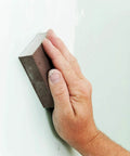 Fine Grit Sanding Sponges 6-Pack For Smooth Finishes On Wood, Metal, And Plastic being used on a wall