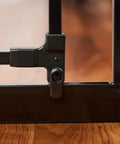 Close-up of latch on extra wide baby gate 29 to 49 inches for doorways and stairs, pressure mounted safety gate with door, black