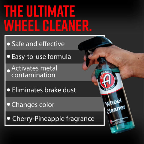 Hand holding bottle of Wheel Cleaner 16oz Tough Spray For Car Wash Detailing That Destroys Brake Dust And Grime, Rim Cleaner.