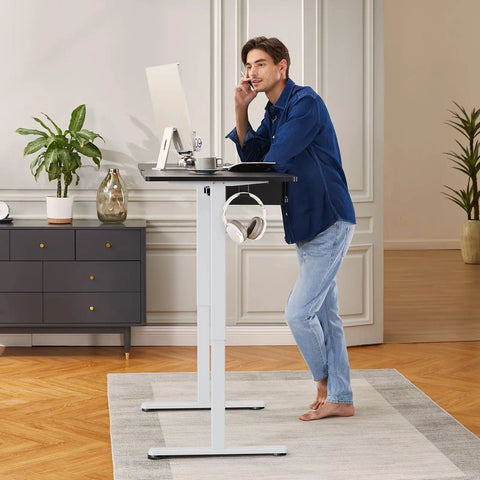 Man using Electric Standing Desk Frame With Four Memory Height Settings For Sit Stand Comfort, Height Range 28.3 To 46.5 Inches
