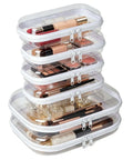 Total Game Changer Clear Hard Shell Travel Organizer Six Pack With Heavy Duty Zipper Seal For Toiletries Cosmetics Tech Cables And Daily Essentials stacked with cosmetics inside.