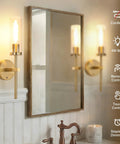 Set Of Two Rechargeable Battery Operated Wall Sconces Featuring Gold Glass Shades Zero Wiring Headaches For A Total Breeze Installation Plus Remote Dimming For Sweet Room Ambiance with a mirror reflection.