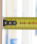 Close-up of Fatmax Tape Measure With Blade Armor And Dual Scale 8m Length extended, showing dual scale and 3.35mm standout