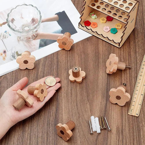 8 Piece Flower Wood Cabinet Knobs Set In Burlywood Two Sizes Cute Floral Drawer Pulls on a table with accessories.