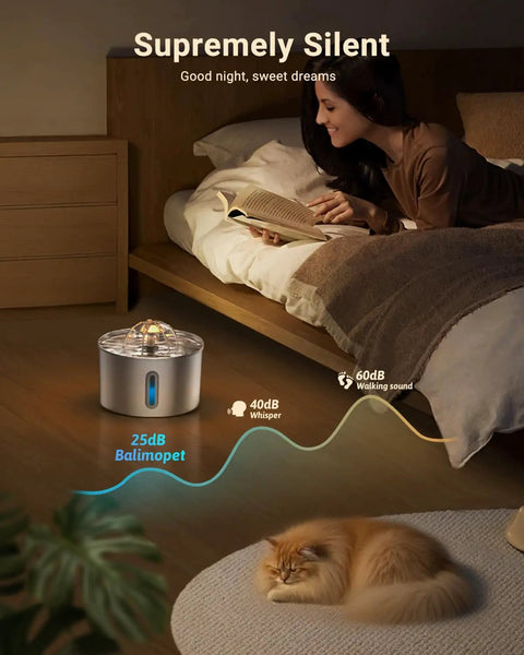 Woman reading next to Stainless Steel Cat Water Fountain 74oz Automatic Pet Water Dispenser with sleeping cat nearby