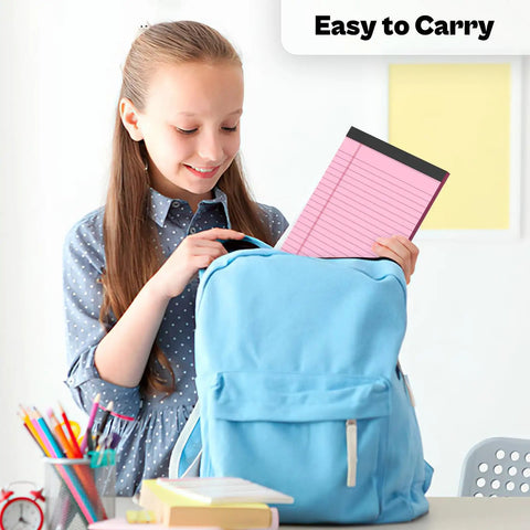 Girl placing a 4 Pack Pink 5x8 Inch Small College Ruled Legal Pad into a blue backpack, ideal for study and office use.