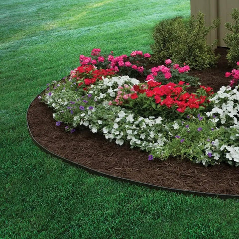Flower bed bordered by 2 Inch Tall Landscape Edging Kit With 20 Ft Coil And 20 Spikes For Lawn Garden Borders Durable Black Plastic Edging.