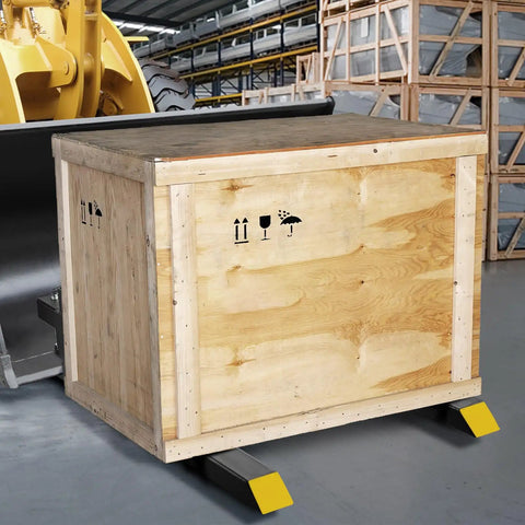 43 Inch Clamp On Pallet Forks For Tractor Buckets, 2000 Lb Capacity, lifting a wooden crate, visible on a skid steer in warehouse