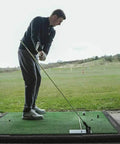 Man using Durable Steel Golf Swing Plane Trainer Plate With Alignment Stick Holder on driving range