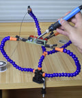 No Sweat Hella Solid Third Hand Soldering Helper With Four Bendable Upright Arms during electronics repair on a circuit board.