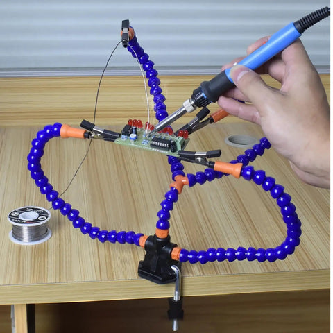 No Sweat Hella Solid Third Hand Soldering Helper With Four Bendable Upright Arms during electronics repair on a circuit board.