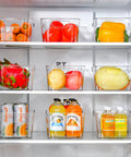 Straight Up Sturdy 12 Pack Clear Plastic Storage Bins With Handles For Pantry Organizing Cabinet Shelving Transparent Food Containers Super Handy For Freezer Closet Under Sink Setup with fruits and drinks in fridge.