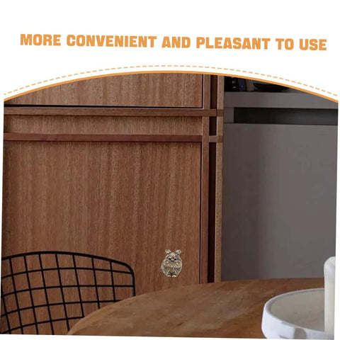 Close-up of cat shaped brass cabinet knob on wooden door, part of Cat Shaped Brass Cabinet Knobs Set For Kitchen Bedroom And Bath.