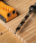 Close-up of Workhorse Pocket Hole Drill Bit Set with depth stop collar in use on wood surface for clean drilling by POWERTEC.