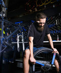 Mechanic using Bike Freewheel Removal And Lockring Tool For 12 Spline Freewheels Shimano SunRace, heavy duty alloy tool in workshop.